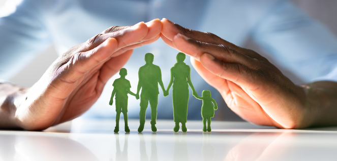 Hands forming a protective gesture over green silhouettes of a family with two adults and two children, symbolizing legal protection, family care, and safeguarding services