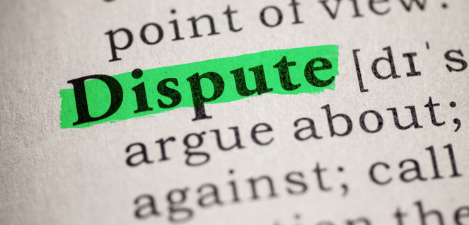 The word "Dispute" highlighted in green in a dictionary or printed text, emphasizing conflict or disagreement.