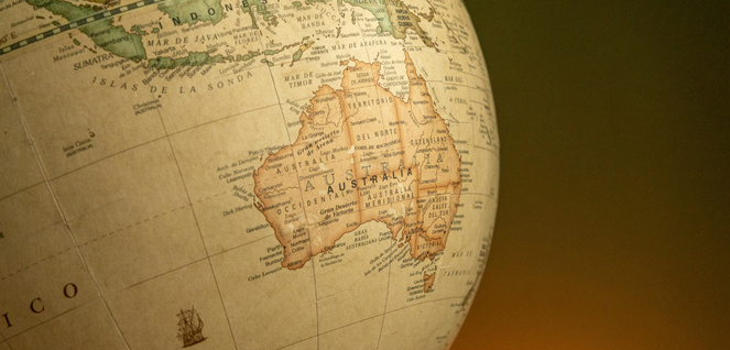 Close-up of a globe showing Australia and nearby regions with labeled cities.